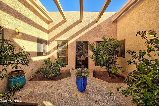 property entrance featuring a patio area