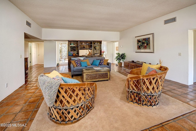 living room with tile patterned flooring and a textured ceiling