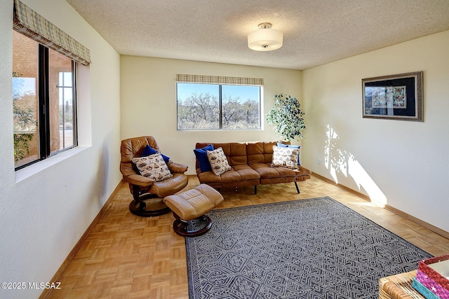 living room featuring light parquet floors and a textured ceiling