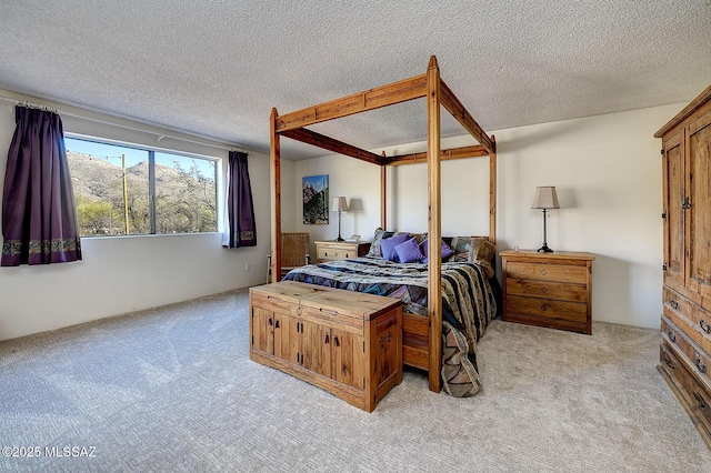 bedroom with light colored carpet and a textured ceiling