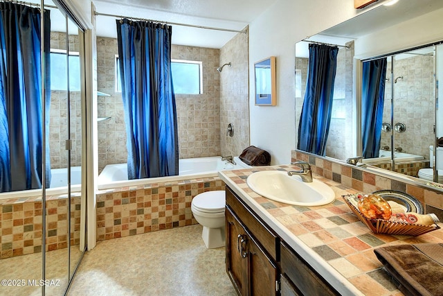 full bathroom featuring vanity, toilet, and tiled shower / bath combo