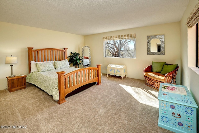 bedroom featuring light colored carpet and a textured ceiling