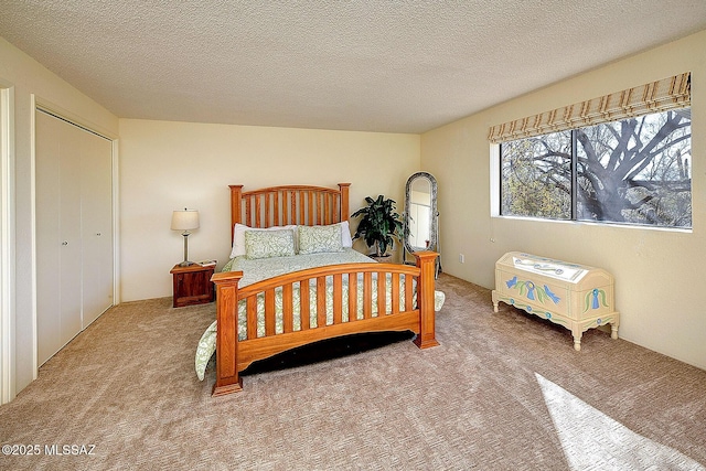 carpeted bedroom featuring a textured ceiling