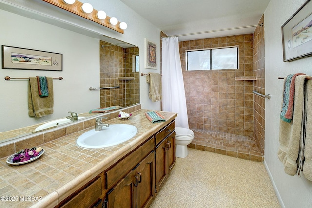 bathroom featuring a shower with curtain, vanity, and toilet