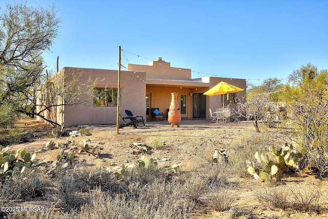 back of house with a patio