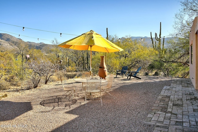 view of yard featuring a mountain view and a patio area