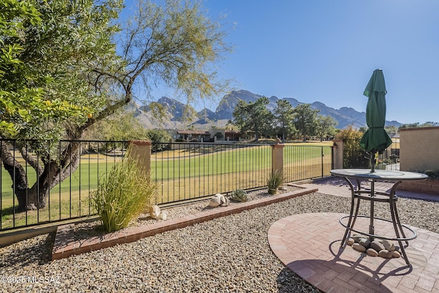 view of yard featuring a mountain view and a patio area