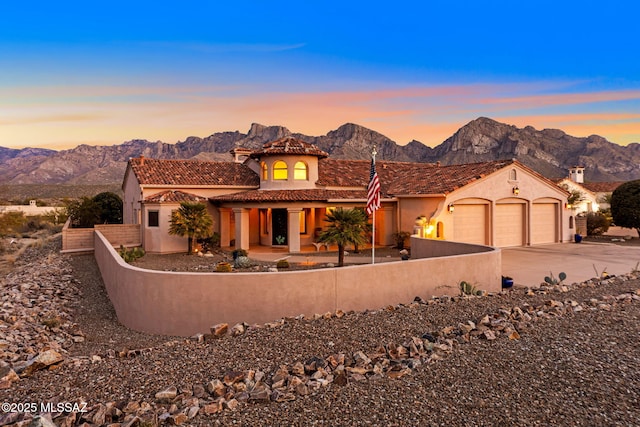 view of front facade with a garage and a mountain view