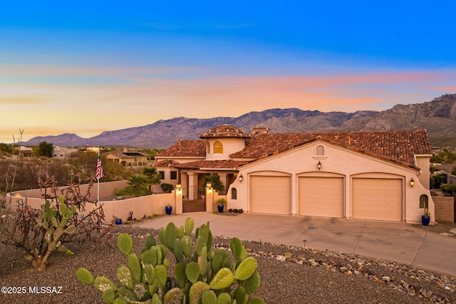 view of front facade with a garage and a mountain view