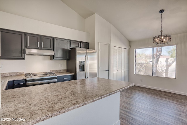 kitchen with light stone counters, decorative light fixtures, stainless steel appliances, a notable chandelier, and dark hardwood / wood-style flooring