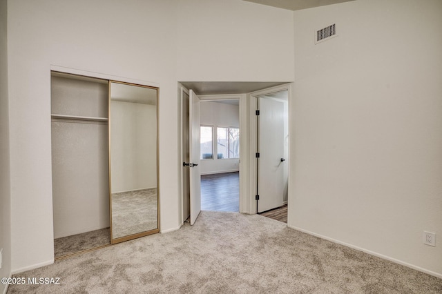 unfurnished bedroom featuring carpet floors and a closet