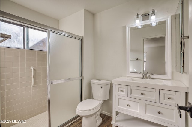 bathroom with toilet, an enclosed shower, wood-type flooring, and vanity