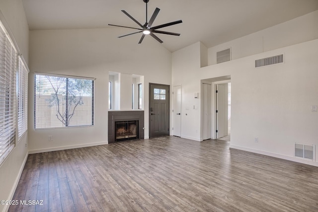 unfurnished living room with high vaulted ceiling, hardwood / wood-style floors, and ceiling fan