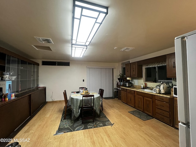 dining room with light hardwood / wood-style flooring