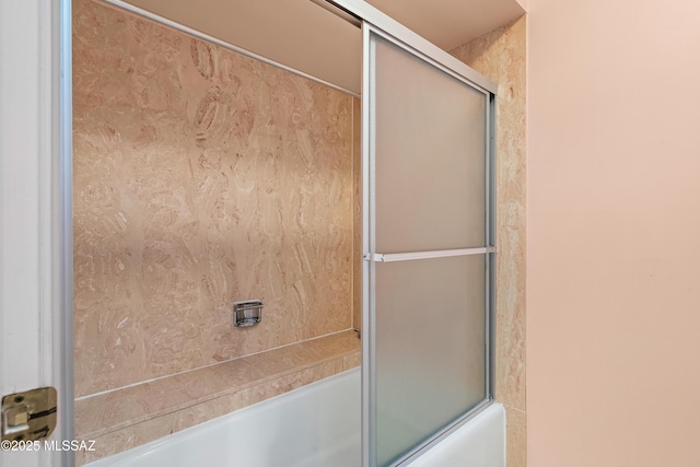 bathroom featuring shower / bath combination with glass door