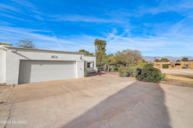 view of front of home featuring a mountain view and a garage