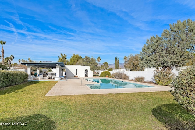 view of swimming pool featuring a patio area and a yard