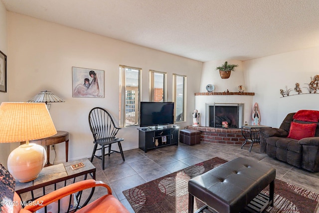 tiled living room featuring a textured ceiling and a fireplace