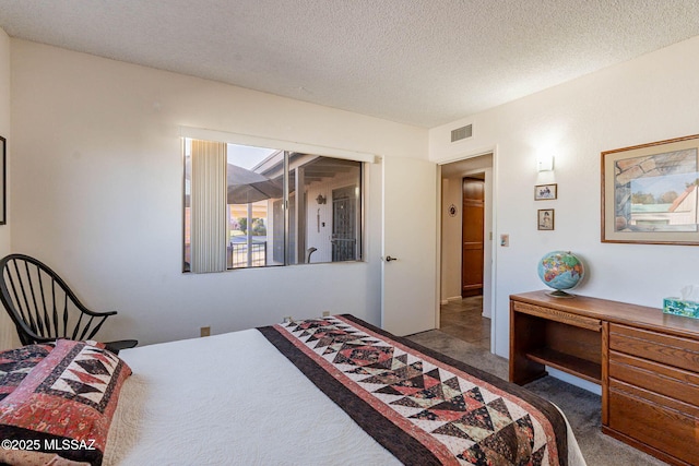 carpeted bedroom featuring a textured ceiling