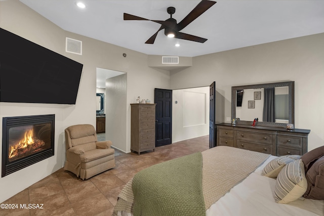 tiled bedroom with ceiling fan and ensuite bathroom