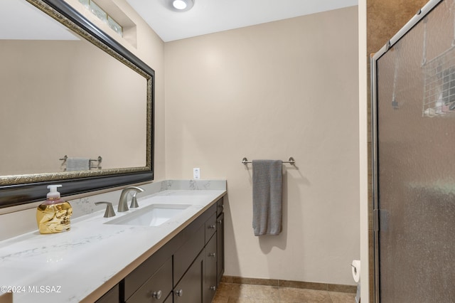 bathroom featuring walk in shower, vanity, and tile patterned flooring