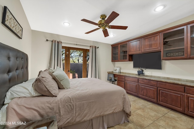 bedroom featuring access to outside, light tile patterned floors, and ceiling fan