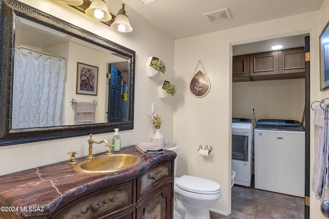 bathroom with separate washer and dryer, toilet, and vanity