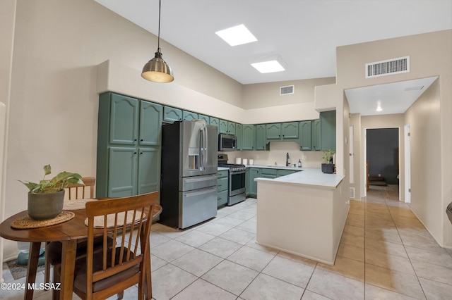 kitchen featuring light tile patterned floors, stainless steel appliances, pendant lighting, and kitchen peninsula