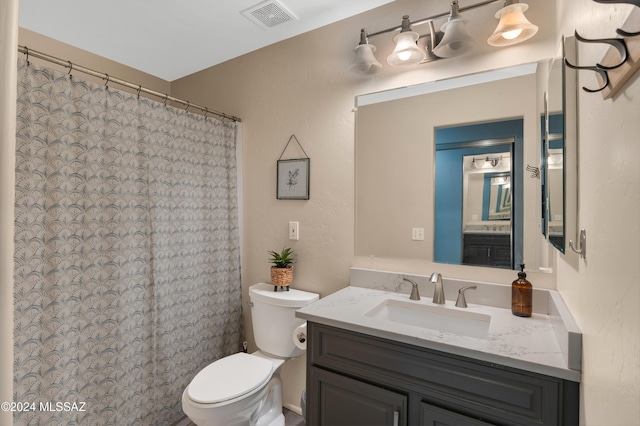 bathroom featuring toilet and vanity