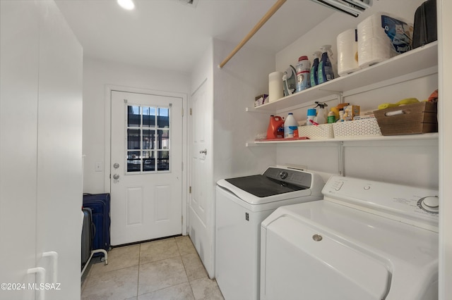 laundry area featuring washing machine and dryer and light tile patterned floors