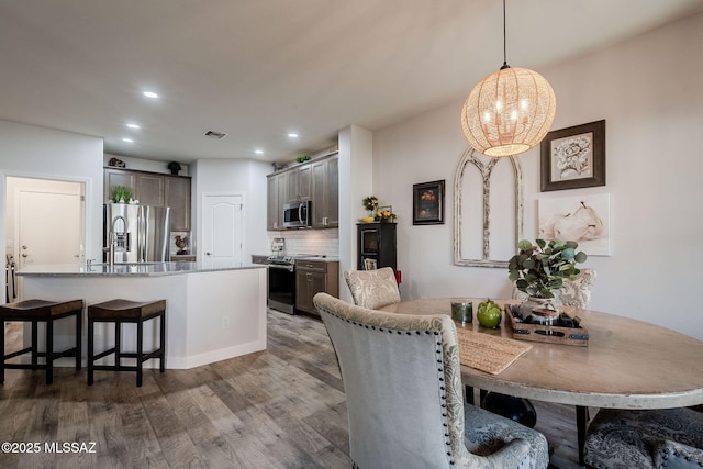 dining space featuring hardwood / wood-style floors