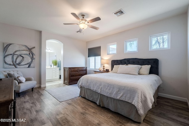 bedroom with ensuite bath, ceiling fan, and wood-type flooring