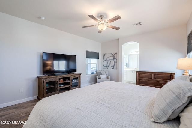 bedroom featuring ensuite bathroom, ceiling fan, and dark wood-type flooring