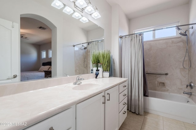 bathroom with shower / tub combo, tile patterned floors, and vanity