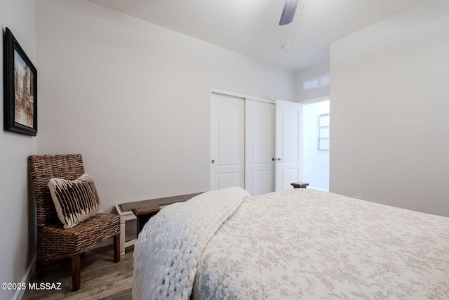 bedroom featuring a closet, wood-type flooring, and ceiling fan