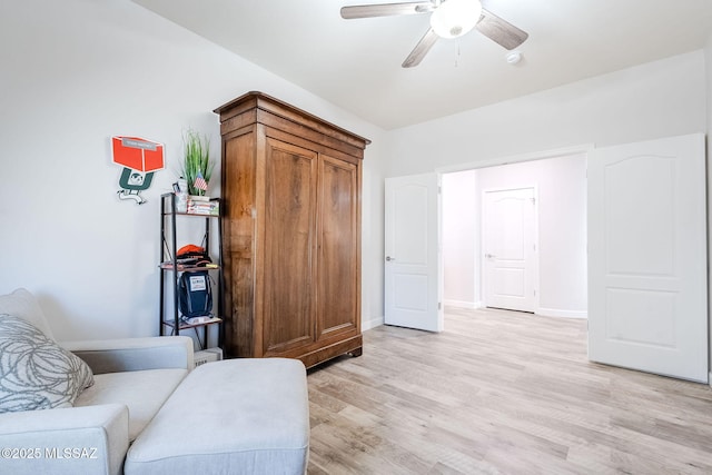 living area with ceiling fan and light hardwood / wood-style flooring