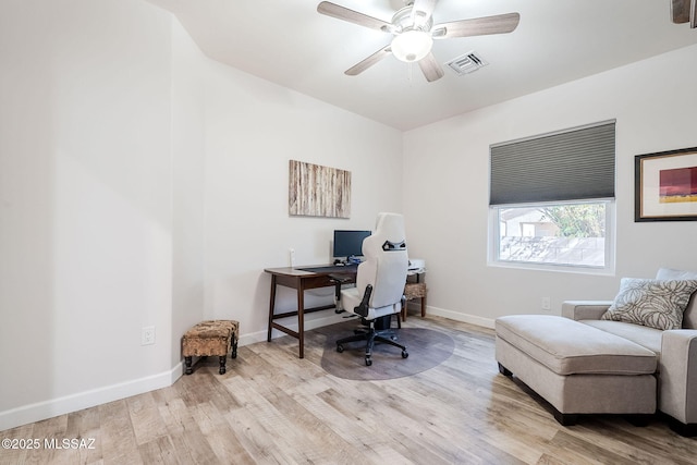 office with light wood-type flooring and ceiling fan