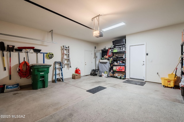 garage with electric water heater and a garage door opener