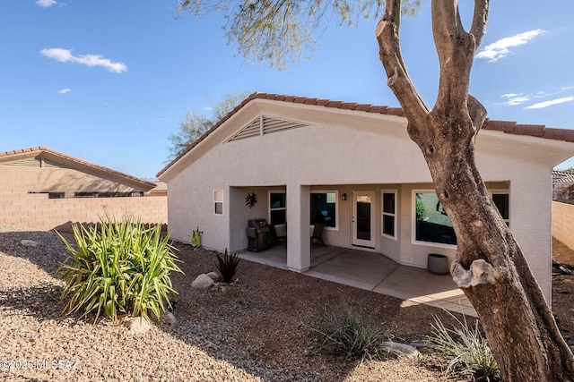 rear view of property featuring a patio area