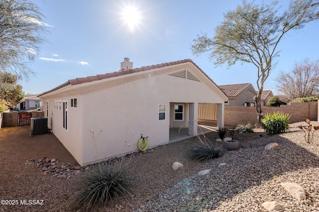 view of side of home with central AC