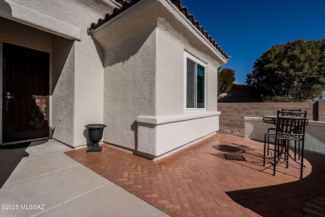 view of side of property featuring a patio