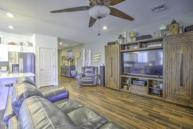 living room with ceiling fan and dark hardwood / wood-style flooring