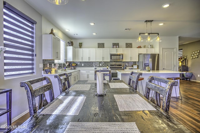 dining room featuring sink and dark hardwood / wood-style floors