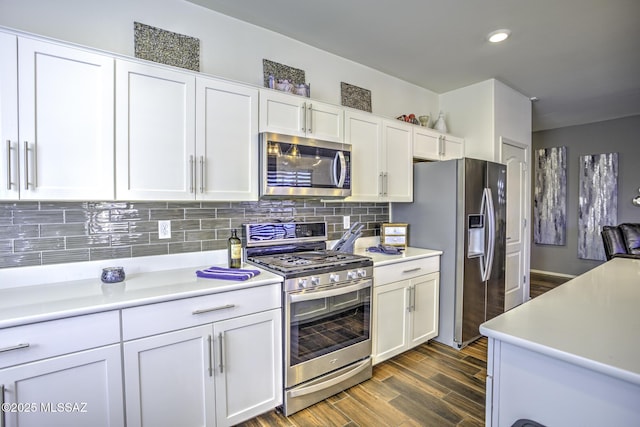 kitchen featuring white cabinets, stainless steel appliances, and tasteful backsplash