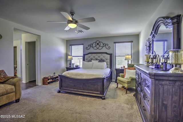 bedroom with ceiling fan and light carpet