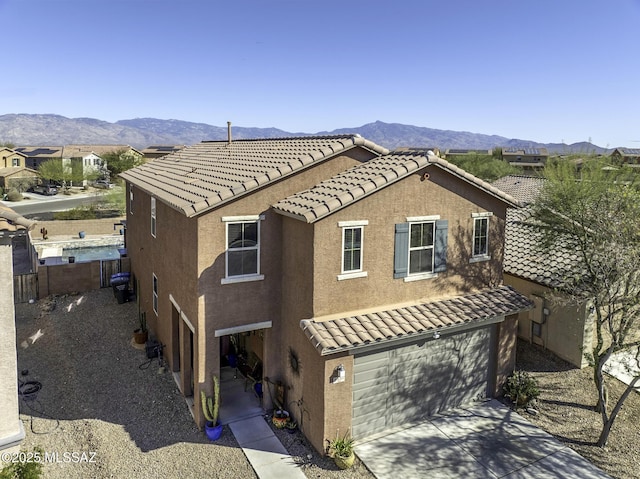 view of home's exterior with a garage and a mountain view