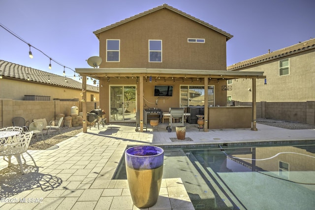 back of house featuring an outdoor bar and a patio