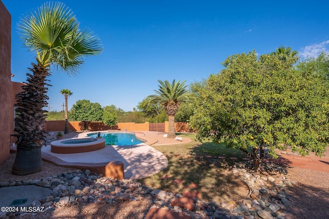 view of pool featuring a patio area and an in ground hot tub