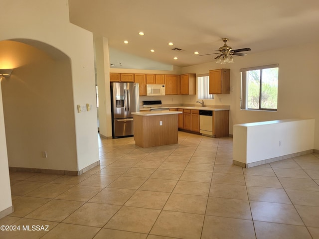 kitchen with white appliances, a center island, ceiling fan, light tile patterned flooring, and sink