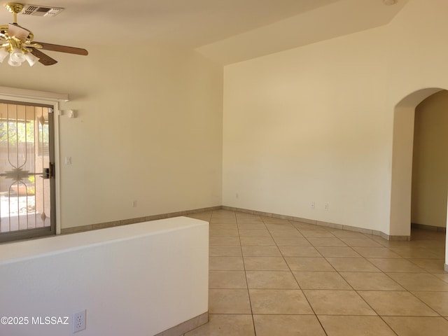 tiled spare room with ceiling fan